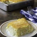 Cheesy homemade copycat Cracker Barrel hashbrown casserole on a plate and in a baking pan.