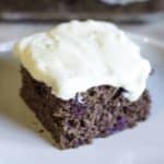 A slice of devil's food cake topped with cream cheese frosting