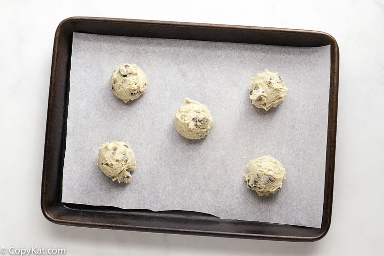 chocolate chip cookie dough on a cookie sheet