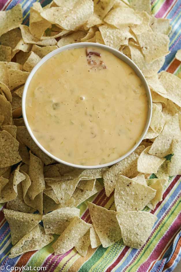 a bowl of copycat cheese queso made with garlic, green chilies, and more 