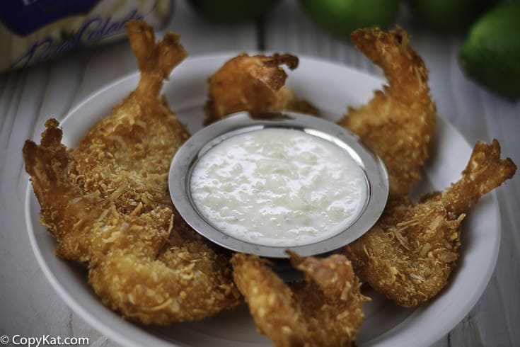 Homemade copycat Red Lobster Pina Colada Dipping Sauce in a bowl with fried shrimp.