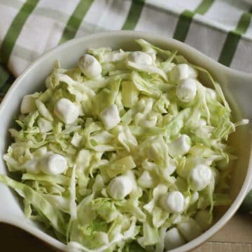 A bowl of coleslaw made with pineapple and marshmallows.