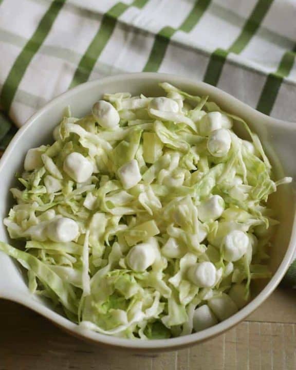 A bowl of coleslaw made with pineapple and marshmallows.