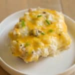 A twice baked potato with mushrooms, sour cream, and cheese