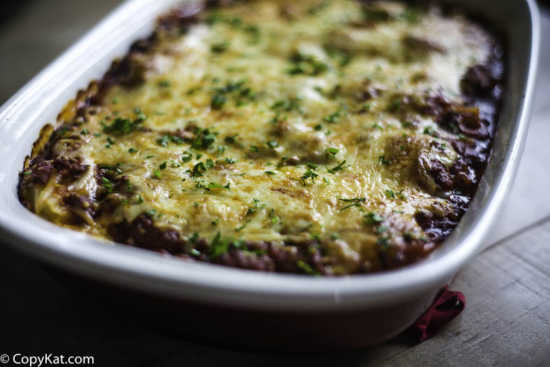 Four cheese manicotti with meat sauce in a baking dish