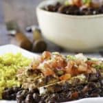 A plate of vegetarian black beans served with pico de gallo