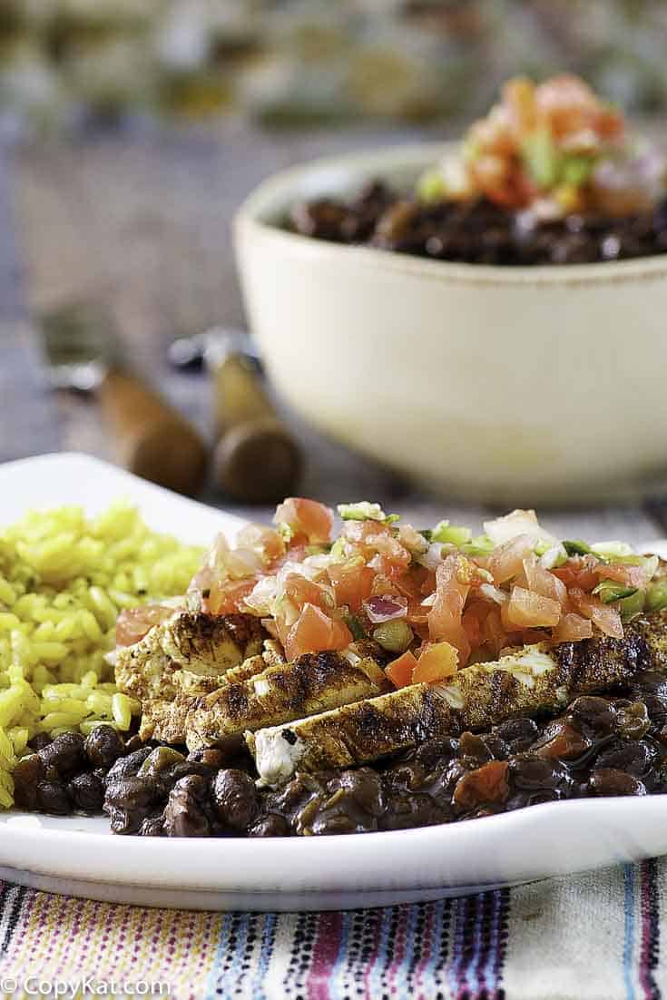 A plate of vegetarian black beans served with pico de gallo