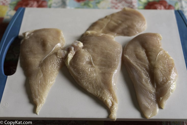 Chicken breasts that have been sliced in half horizontally.