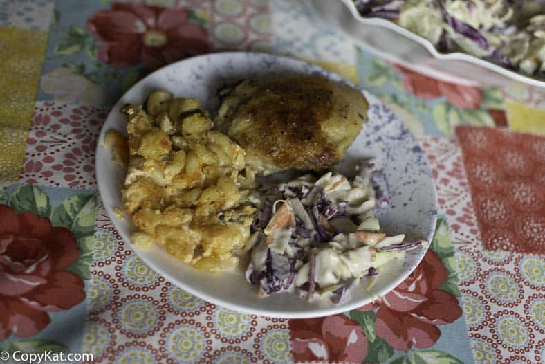 A plate with Famous Dave's Coleslaw baked chicken and macaroni and cheese