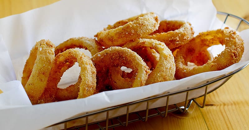 Homemade Sonic Onion Rings on parchment in a serving basket.