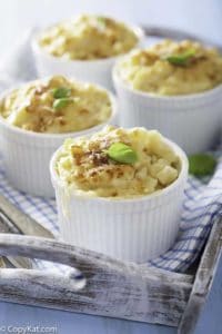 Four individual ramekins of baked macaroni and cheese