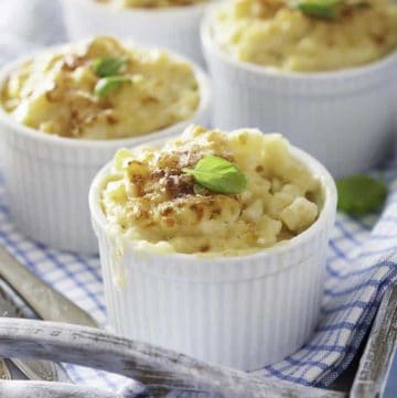 Four individual ramekins of baked macaroni and cheese