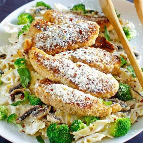 Pan-fried parmesan chicken pasta with creamy wine sauce.
