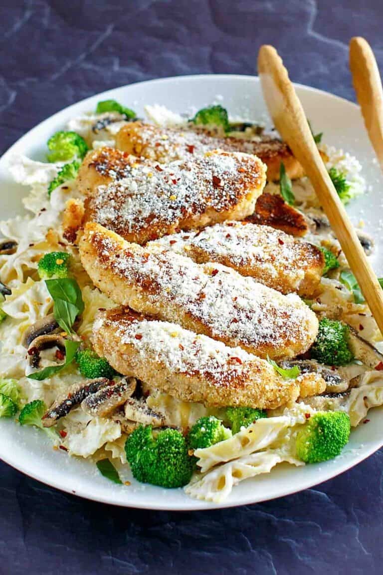 Pan-fried parmesan chicken pasta with creamy wine sauce.