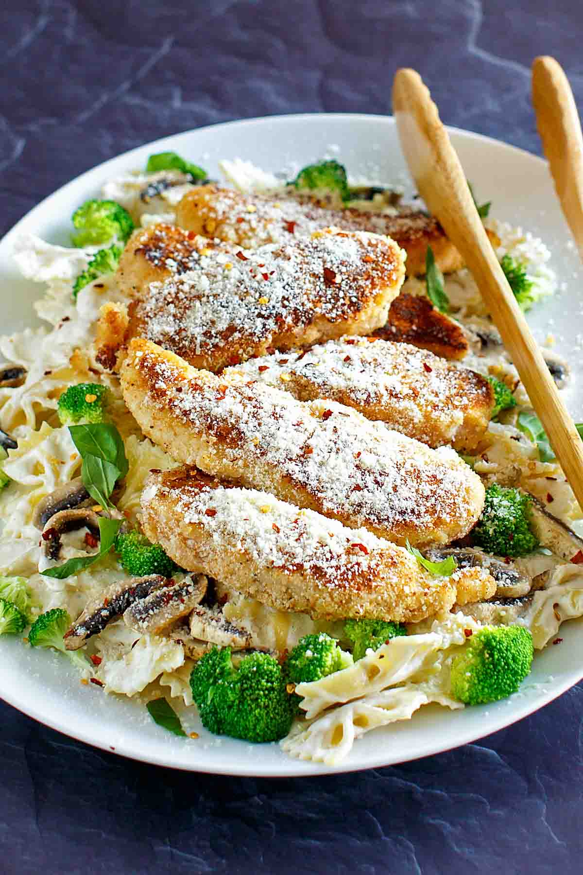 Pan-fried parmesan chicken pasta with creamy wine sauce.