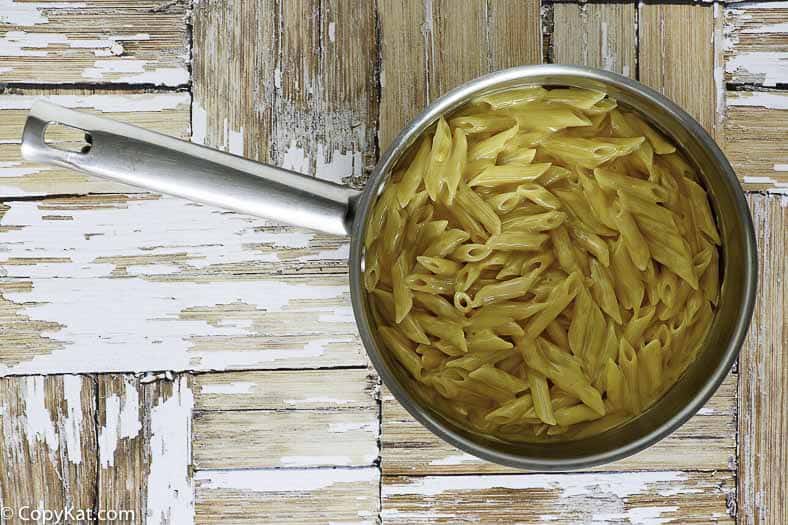 Homemade copycat Outback Steakhouse mac and cheese in a stainless steel pan.