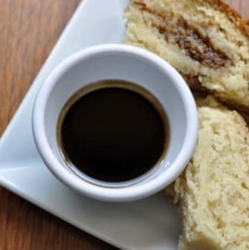 Guinness dipping sauce and 2 slices of Irish soda bread on a plate