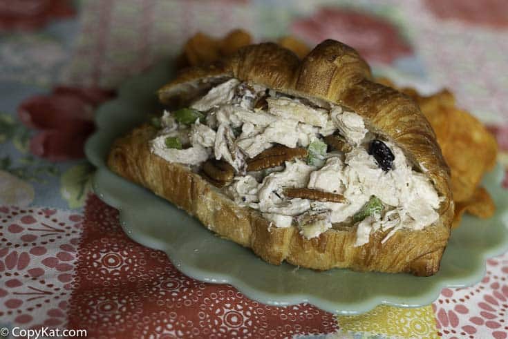 Chicken salad in a croissant made with chicken breast, celery, nuts, and dried fruit. 