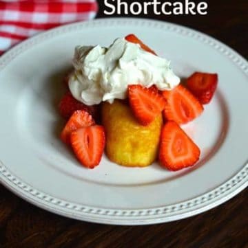 Cut up strawberries served over a twinkie with whipped cream.