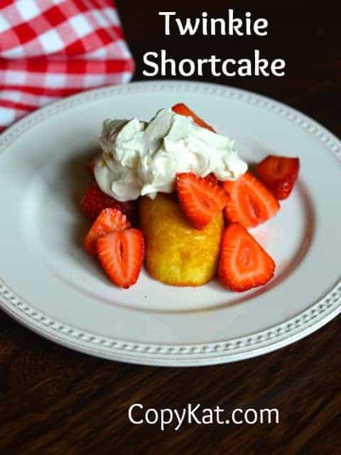 Cut up strawberries served over a twinkie with whipped cream.