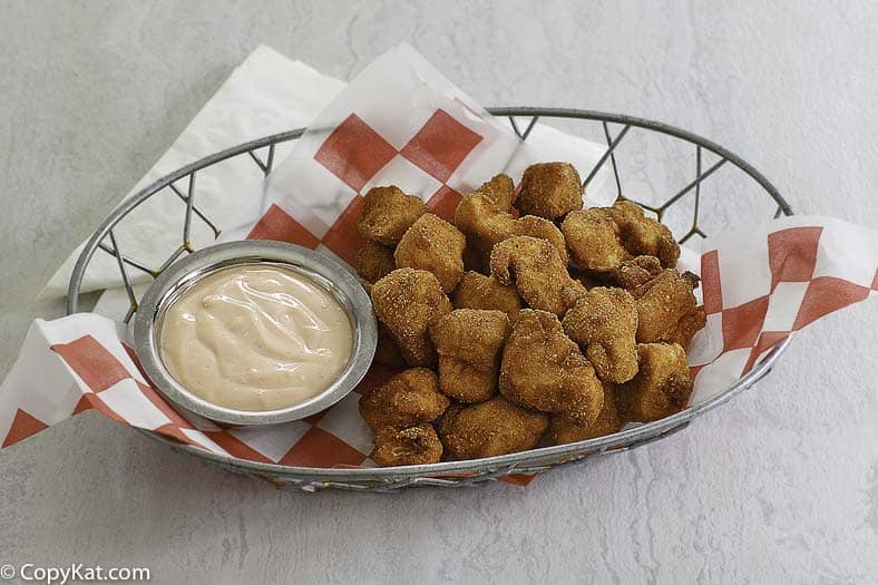 homemade chicken nuggets in a basket with a dipping sauce