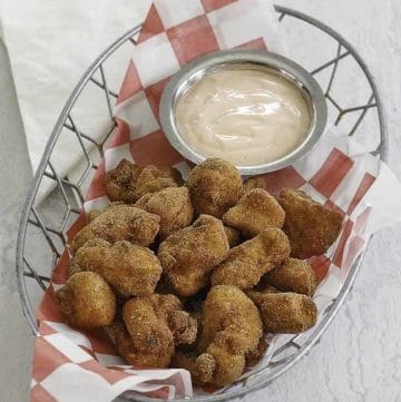 chicken nuggets and dipping sauce in a wire basket