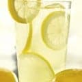 a glass of lemonade with lemon slices