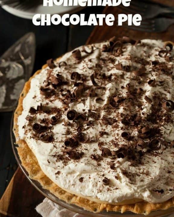 homemade chocolate pie topped with whipped cream and chocolate shavings