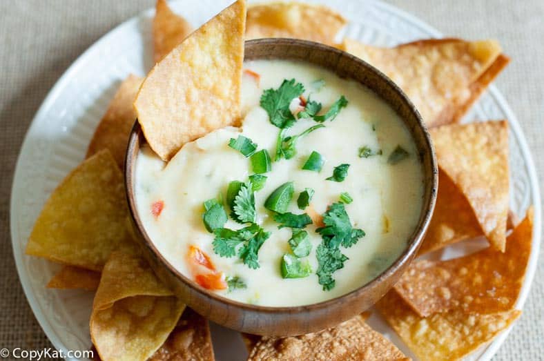 Homemade Applebees Queso Blanco and chips on a platter.