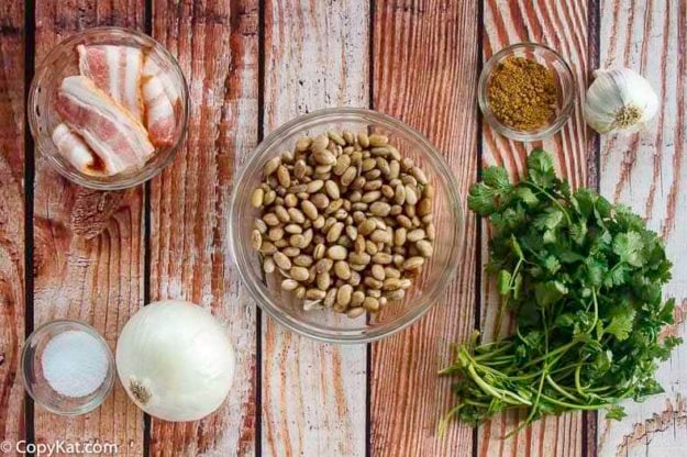 Dried pinto beans, chopped onion, cilantro, and more to make refried beans.