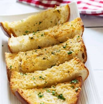 Slices of homemade Parmesan Cheese Garlic Bread on a plate