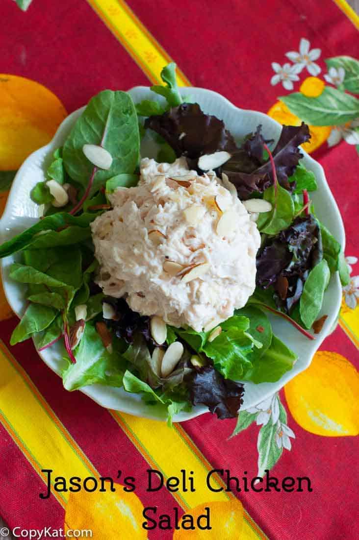 Homemade copycat Jason's Deli Chicken Salad on top of mixed greens on a plate.. 