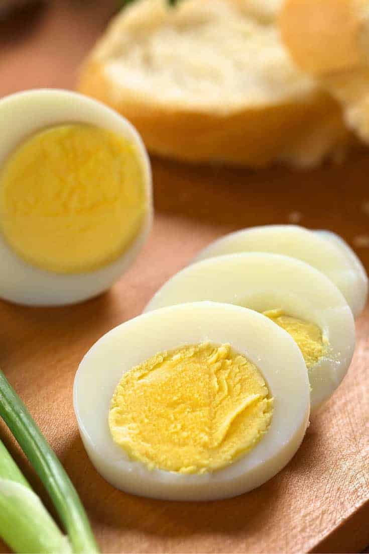Hard boiled egg slices on a cutting board