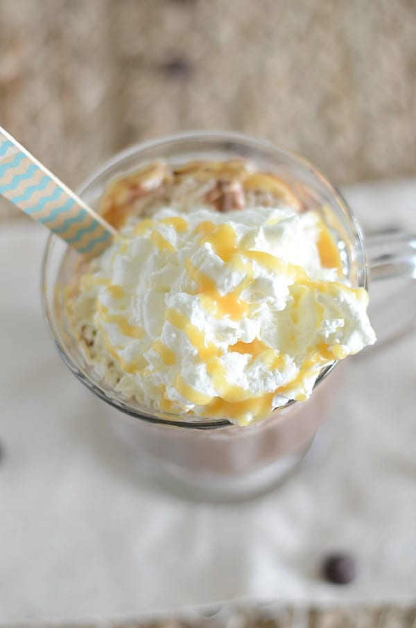 salted caramel hot chocolate topped with whipped cream and caramel syrup