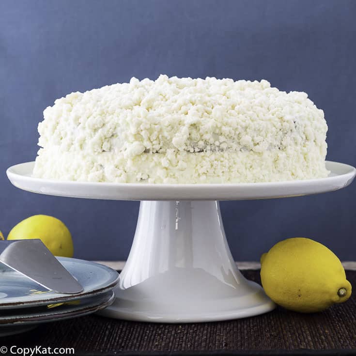 Homemade Olive Garden Lemon Cream Cake on a cake stand.