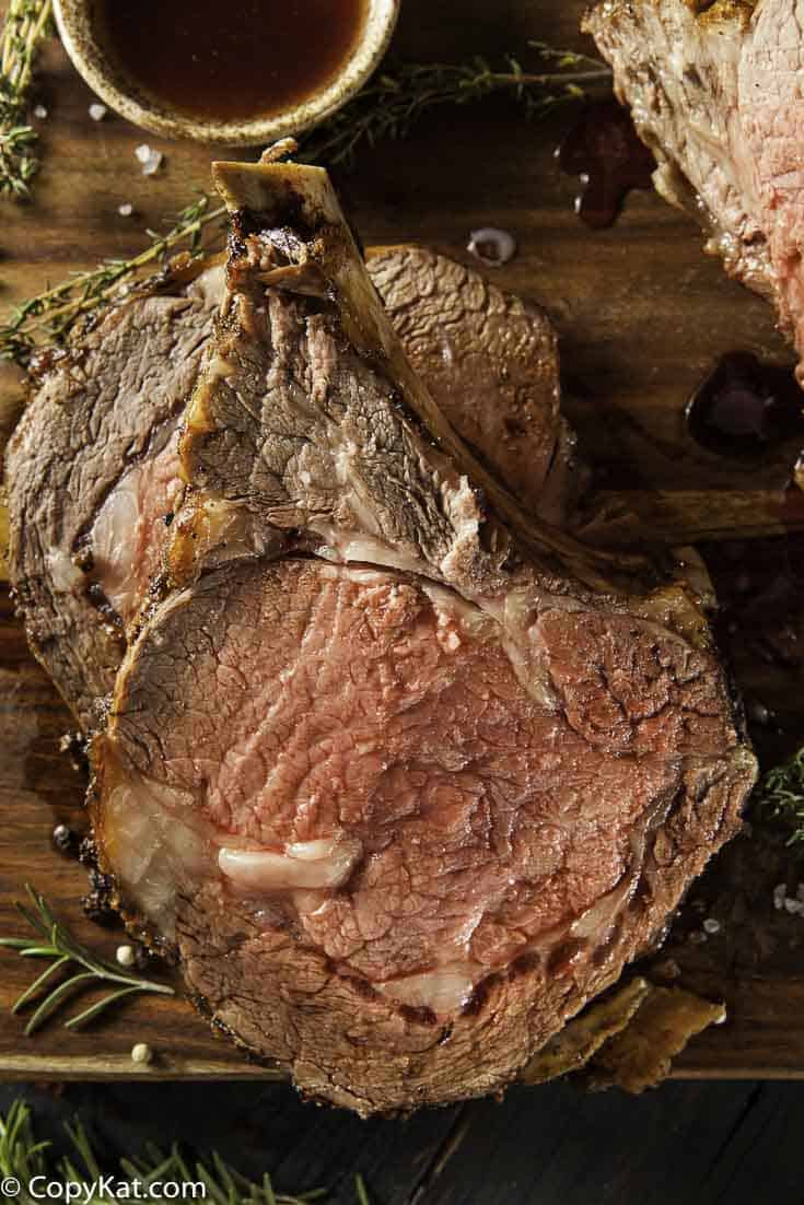 Roast beef slices on a wood cutting board.