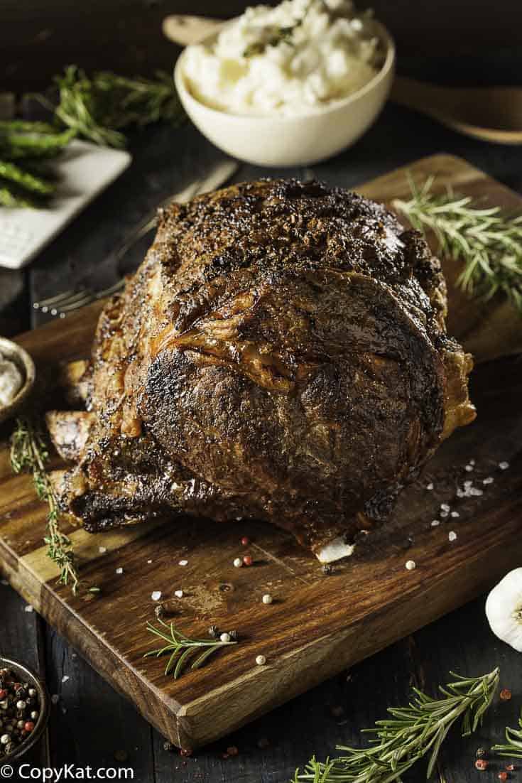 Roast beef on a wood cutting board.