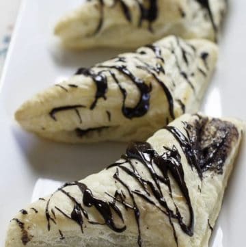 three homemade Arby's chocolate turnovers on a platter