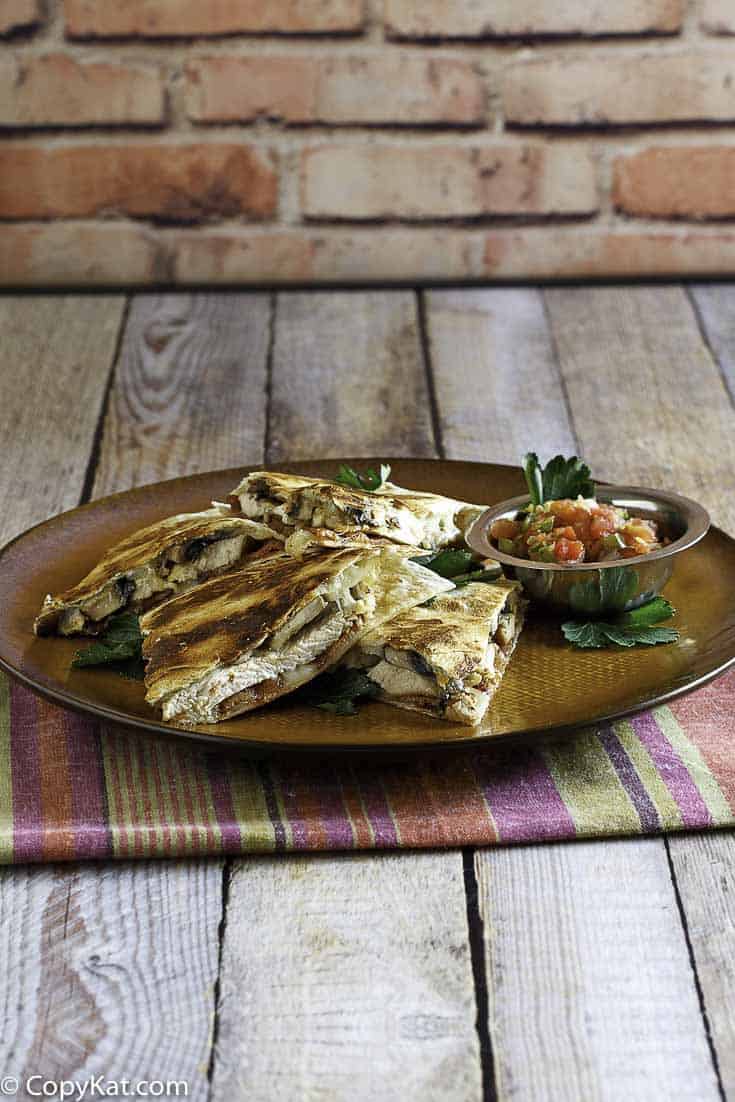 Homemade copycat Alice Springs Quesadilla on a brown plate.