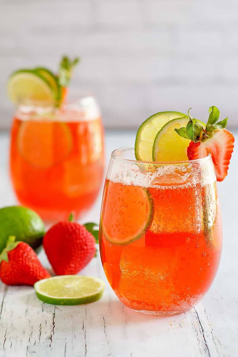 Copycat Sonic strawberry limeade drinks, limes, and strawberries.