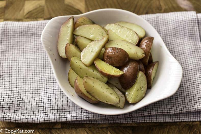 Garlic dill potato wedges in a serving dish