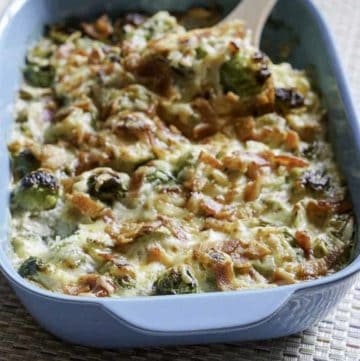 Brussels Sprouts Au Gratin in a blue baking dish