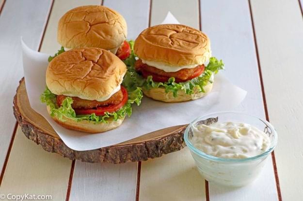 Homemade McDonald's Tartar sauce in a small trencher next to fish filet sandwiches.