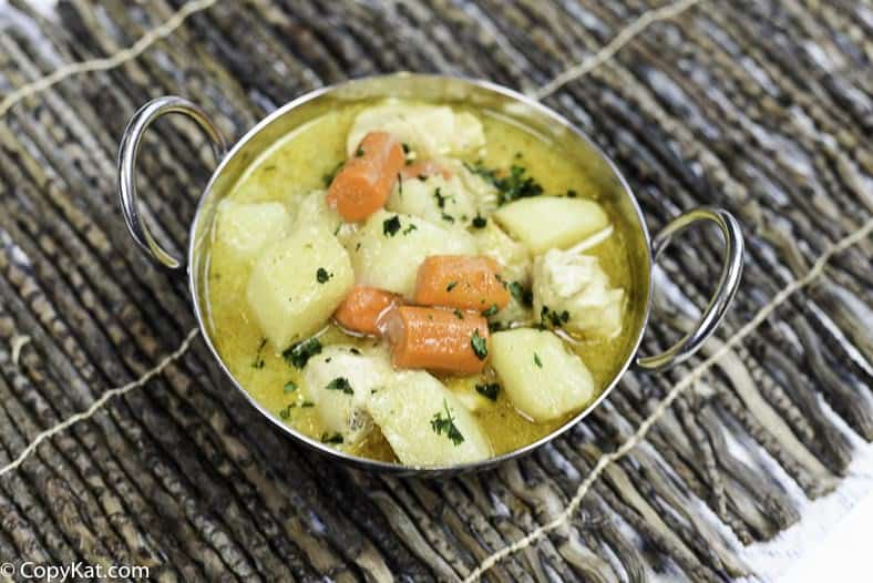 Thai yellow chicken curry with potatoes and carrots in a serving dish.