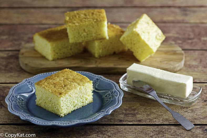 Homemade Boston Market Cornbread slices on a plate and cutting board