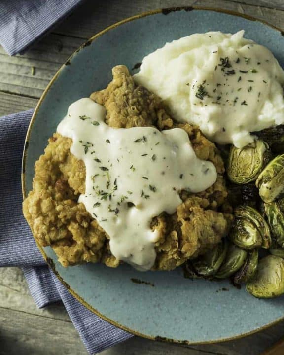 Homemade Southern Chicken Fried Steak and gravy with Brussels sprouts and mashed potatoes