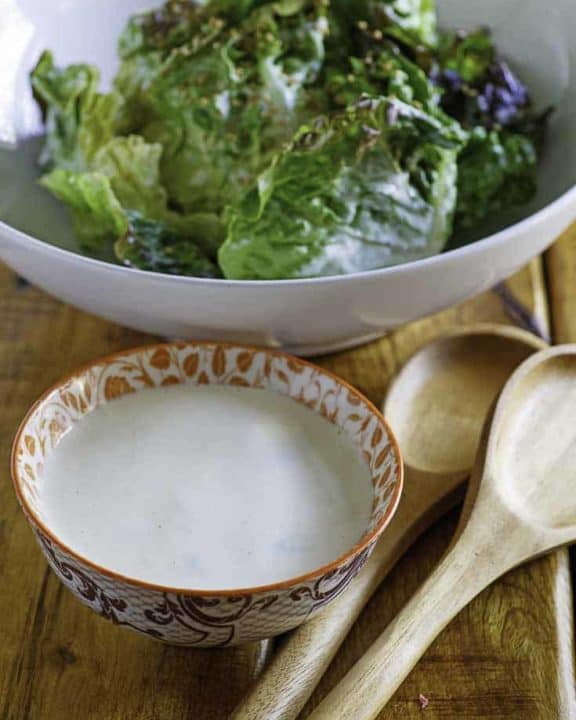 Creamy Japanese Salad Dressing in a small bowl in front of a bowl of lettuce.