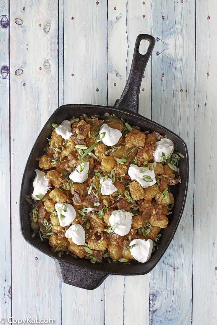 loaded tater tots in a skillet