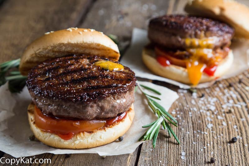 Two grilled burgers with cheese