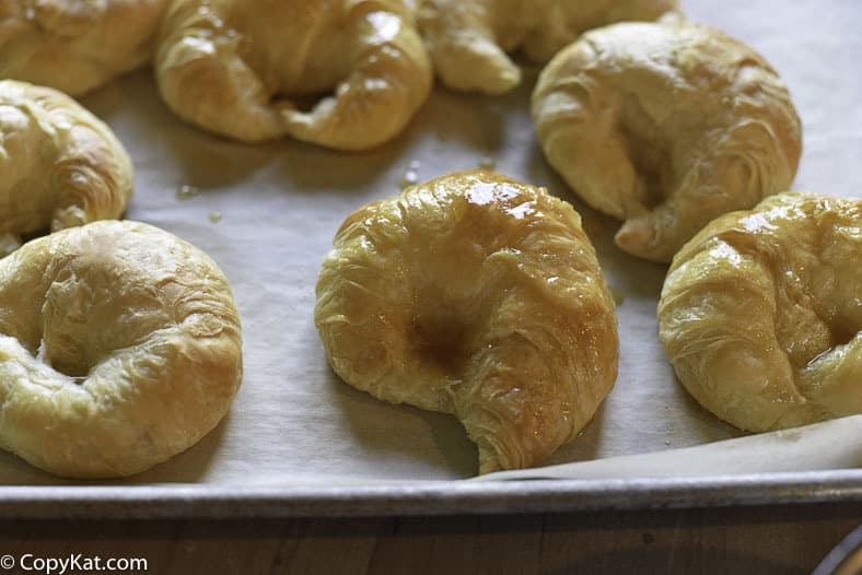 honey butter croissants on a baking sheet